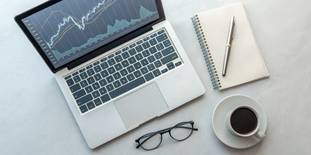 Laptop showing charts and graphs for a client market analysis report.